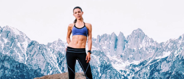 actress Kate Mansi in yoga wear poses in front of mountain